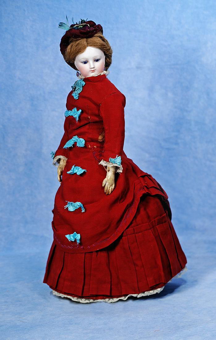 FRENCH BISQUE POUPEE WITH DEHORS NECK ARTICULATION: 210. FRENCH BISQUE POUPEE WITH DEHORS NECK ARTICULATION. 17”. Marks: None visible. Bisque swivel head on kid-edged bisque shoulderplate, Dehors neck articulation which allows her to tilt her hea