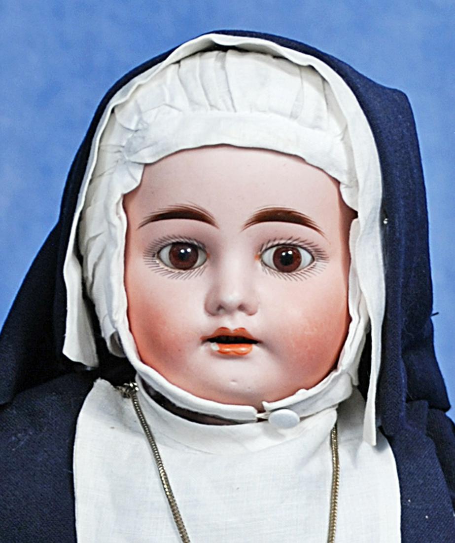 GEBRUDER KUHNLENZ BISQUE DOLL IN NUN HABIT: 268. GEBRUDER KUHNLENZ BISQUE DOLL IN NUN HABIT. 16”. Marks: 44-27. Bisque socket head, stationary brown glass eyes, open mouth, accented lips, upper teeth, composition jointed body, dressed as