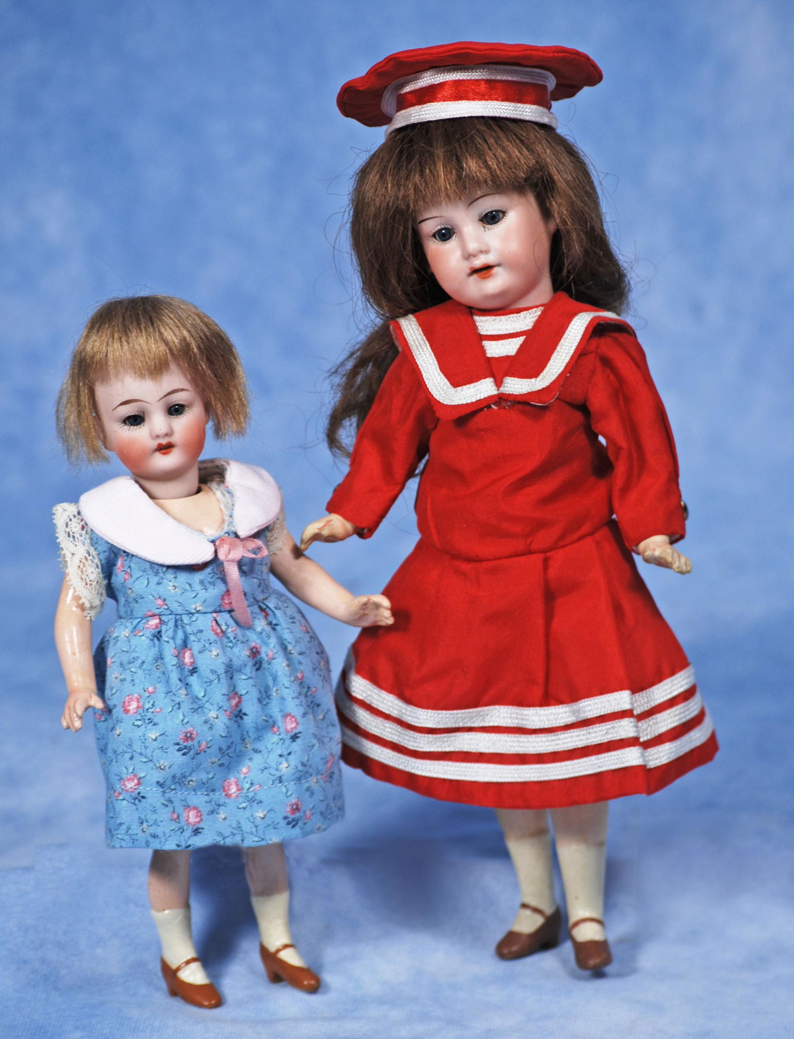 TWO PETITE GERMAN BISQUE FLAPPER-TYPE DOLLS: 271. TWO PETITE GERMAN BISQUE FLAPPER-TYPE DOLLS. 7 ½” doll by Kammer & Reinhardt. Marks: K * R. Bisque socket head, blue sleep eyes, open mouth, upper teeth, mohair wig, five-piece jointed