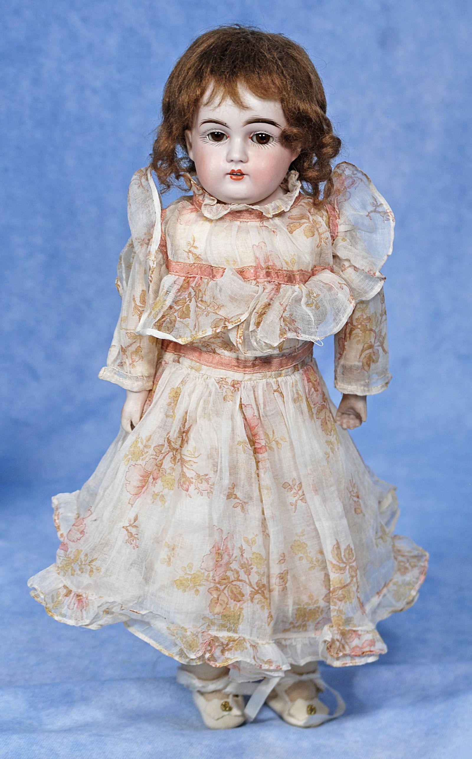 KESTNER PETITE BISQUE DOLL WITH TRUNK AND WARDROBE: 279. KESTNER PETITE BISQUE DOLL WITH TRUNK AND WARDROBE. 13”. Marks: Bisque shoulderhead, brown sleep eyes, painted lashes, feathered brows, open mouth, upper teeth, original mohair wig over pla