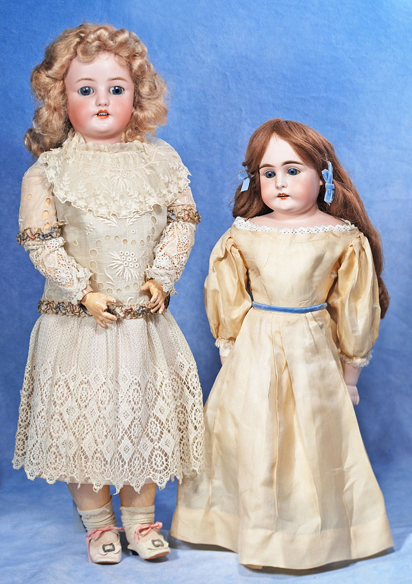 TWO GERMAN BISQUE DOLLS: 304. TWO GERMAN BISQUE DOLLS. (1) 24” doll marked C.M. Bergmann, S & H; bisque socket head, blue sleep eyes, open mouth, pierced ears, synthetic wig, composition ball-jointed body, lace dress, a