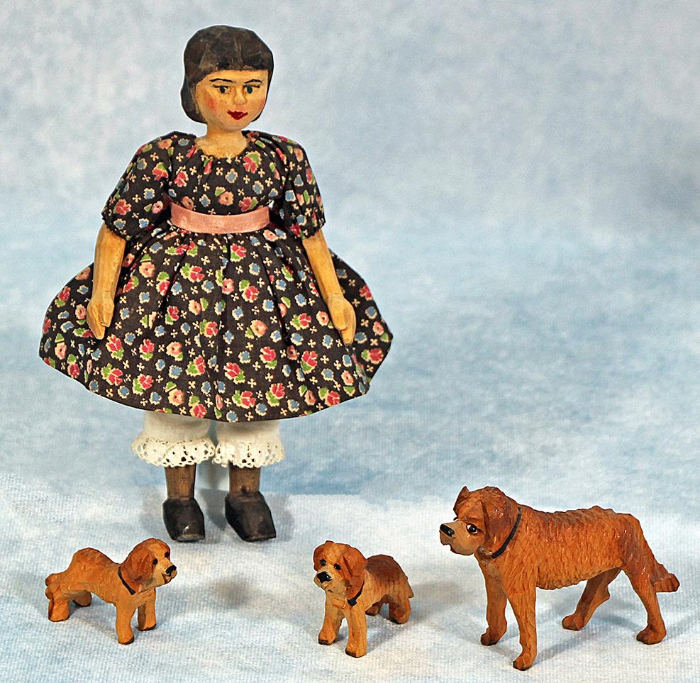 WOODEN CARVED "HITTY" AND WOOODEN FIGURINES.: WOOD CARVED HITTY AND FIGURINES. 6 1/4" hand carved "Hitty" has shoulder head and jointed arms and legs, painted and carved features, wears black dress with flowers over white underskirt and pants wit