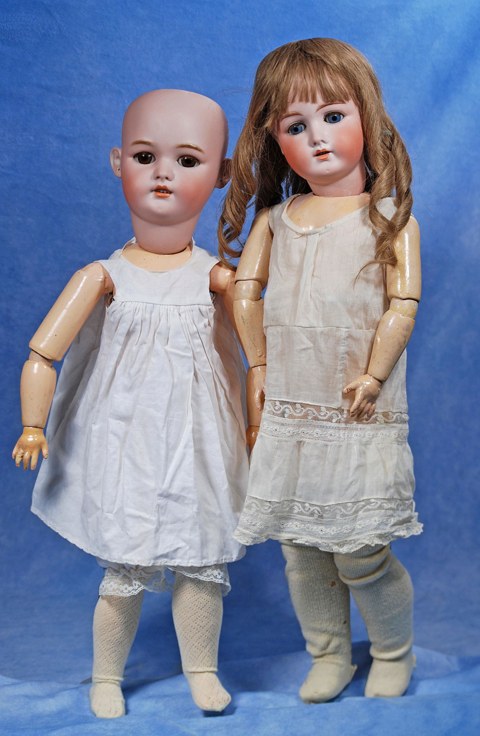 TWO GERMAN BISQUE DOLLS.: TWO GERMAN BISQUE DOLLS. (1) 22" doll marked Germany 3. Bisque socket head, blue sleep eyes, painted lashes and applied lashes, open mouth, accented lips, upper teeth, mohair wig, composition ball-joi