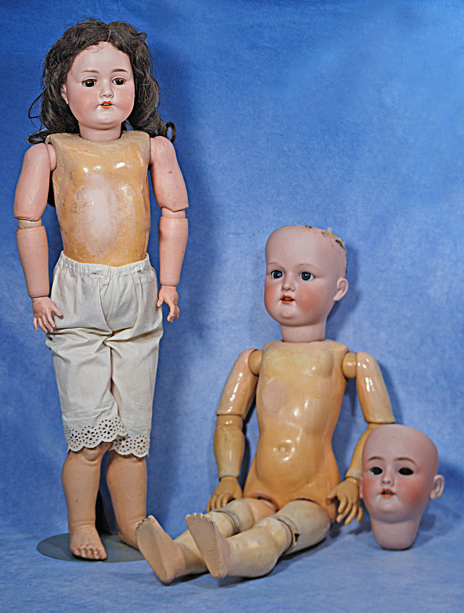 TWO GERMAN BISQUE DOLLS AND BISQUE DOLL HEAD (1 of 1)