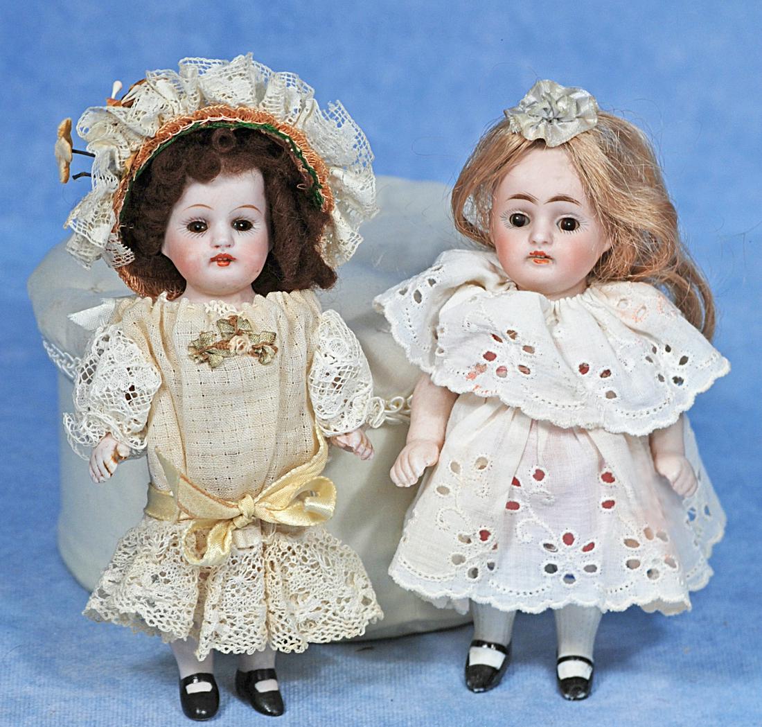 PAIR OF GERMAN ALL-BISQUE DOLLS BY KESTNER: PAIR OF GERMAN ALL-BISQUE DOLLS BY KESTNER. 5 ½”. Marks: 150. Each is all-bisque, jointed at shoulders and hips, open mouth, upper teeth, mohair wig, painted knee stockings and black one-st