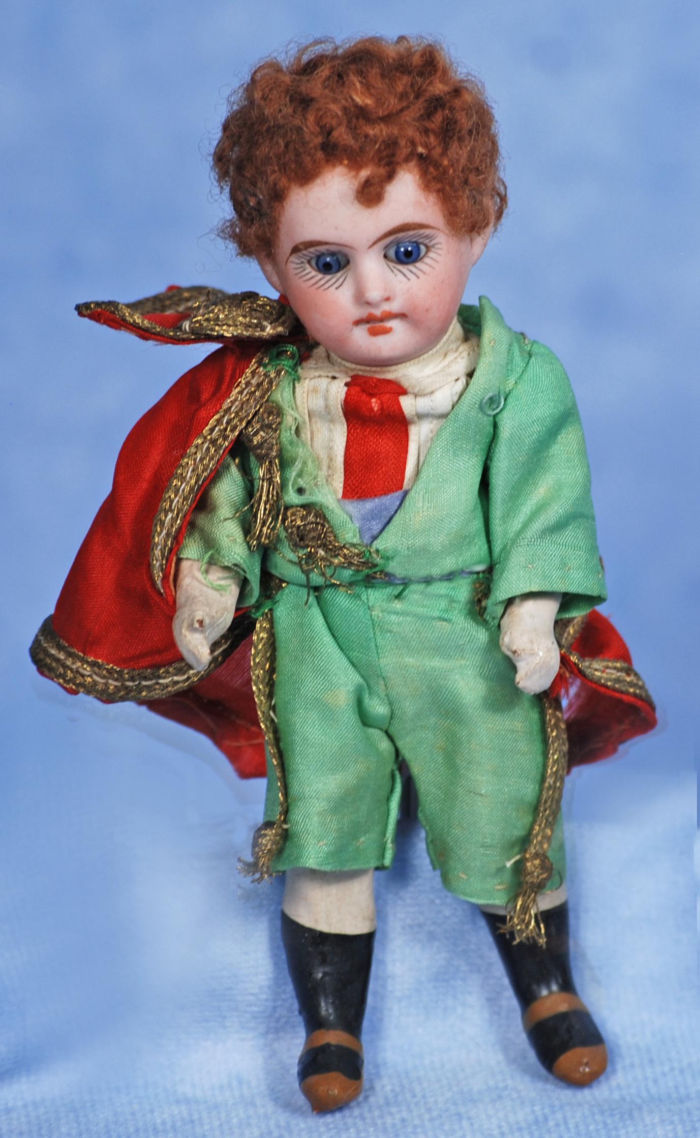 MINIATURE GERMAN BISQUE DOLL BY MYSTERY MAKER: MINIATURE GERMAN BISQUE DOLL BY MYSTERY MAKER. 5”. Maris: 18/ 6. Bisque socket head, stationary blue glass eyes, painted lashes, tapered brows, open mouth, upper teeth, curly mohair wig, five-pi