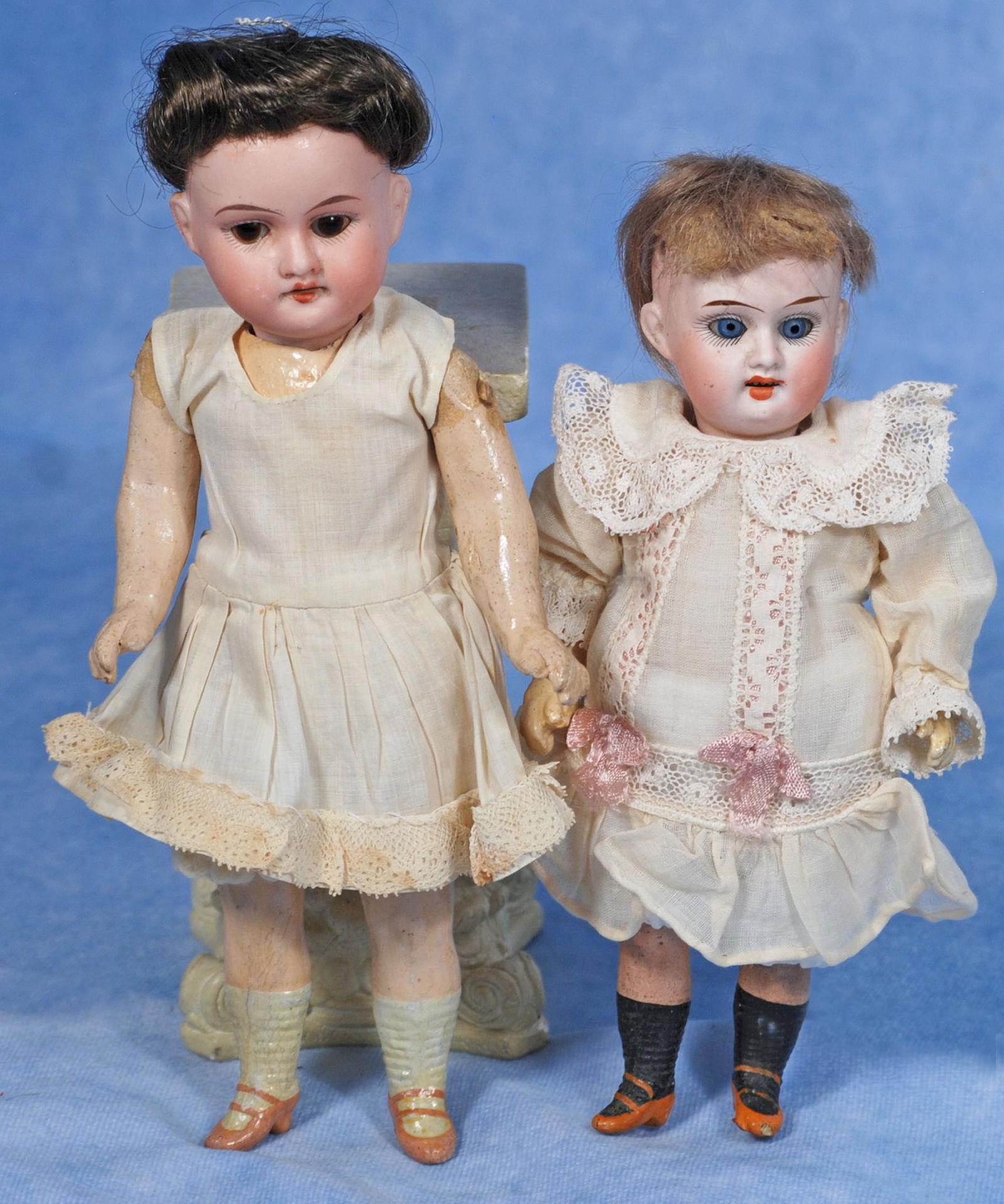 TWO GERMAN BISQUE DOLLS: TWO GERMAN BISQUE DOLLS. Each is bisque socket head with sleep eyes, painted lashes, tapered brows, open mouth, upper teeth, mohair or human hair wig, five-piece jointed composition body, painted shoe