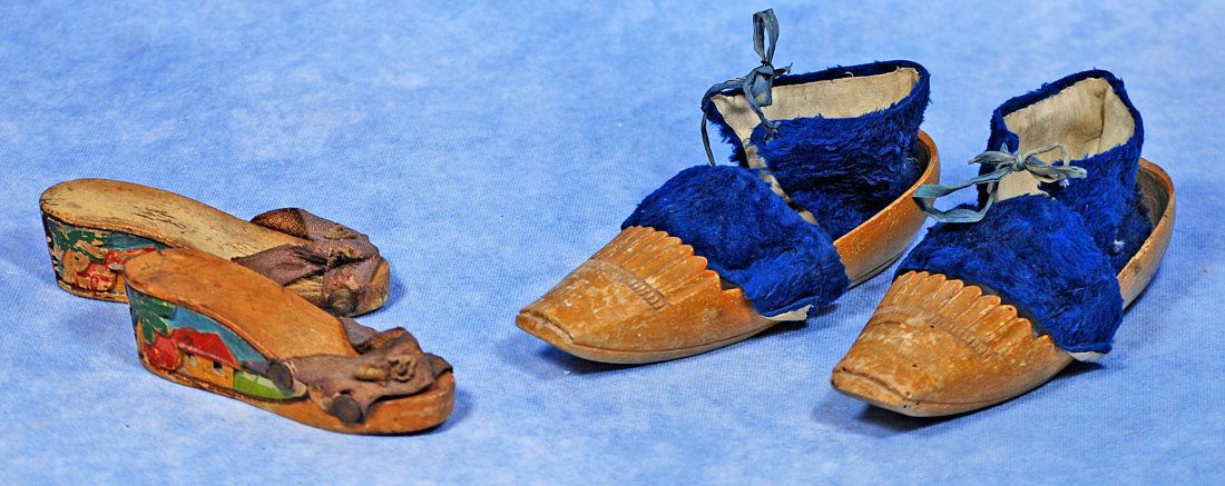 TWO PAIRS OF ANTIQUE SHOES: TWO PAIRS OF ANTIQUE SHOES. 4 ½” pair of sandals with cobbled wooden soles having applied scenic designs, brown fabric uppers; 6 ½” pair of cobbled wooden folk shoes with int