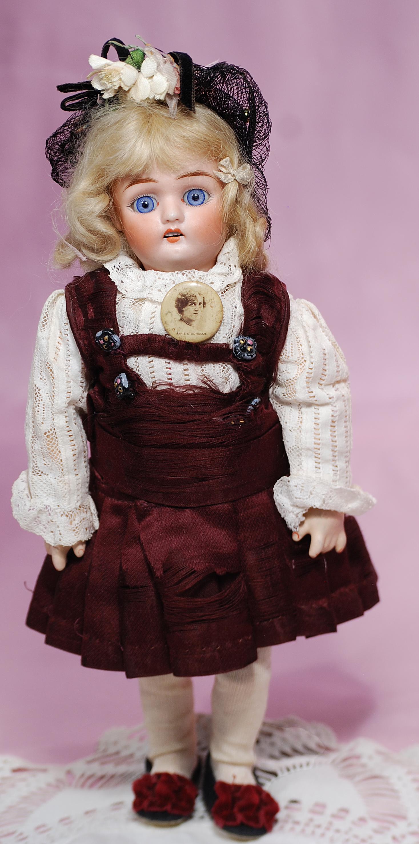 PETITE GERMAN BISQUE DOLL BY MYSTERY MAKER: 29. PETITE GERMAN BISQUE DOLL BY MYSTERY MAKER. 10”. Marks: 5. Bisque socket head, stationary blue paperweight eyes, painted lashes, feathered brows, open mouth, accented lips, upper teeth, blonde m