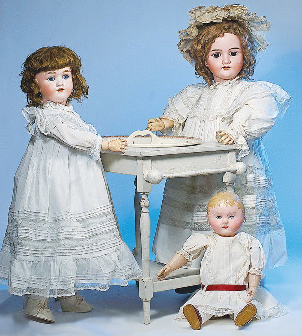 ANTIQUE KATE GREENAWAY-STYLE DOLL'S WASHSTAND: Marks: Sarreguemines mark on bottom. 18" H. x 22" W. x 14" D. French china divided bowl decorated with Kate Greenaway-period nursery rhyme scenes and figures; fits in a painted white wooden washstand 