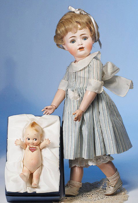 R. JOHN WRIGHT "KLASSIC KEWPIE": 8". All felt Kewpie has jointed arms and legs, rooted mohair topknot, painted Kewpie features, label on chest. The first issue of Wright's Kewpie Series, circa 1999. Commentary: Mint-in-box.