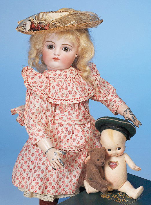 R. JOHN WRIGHT "KEWPIE WITH TEDDY": 6". All-felt, fully jointed, swivel head, blue felt wings, chest sticker, green felt RJW Club hat, label on back #195 of limited edition of 520 pieces; 2 1/2" mohair, fully jointed brown felt teddy be