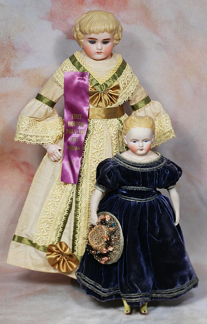 GERMAN BISQUE LADY WITH GLASS EYES: 4. GERMAN BISQUE LADY WITH GLASS EYES. 14”. Marks: None. Bisque shoulderhead with deeply-sculpted and comb-marked blonde hair arranged in bangs and curls, inset blue glass eyes, painted lashes,