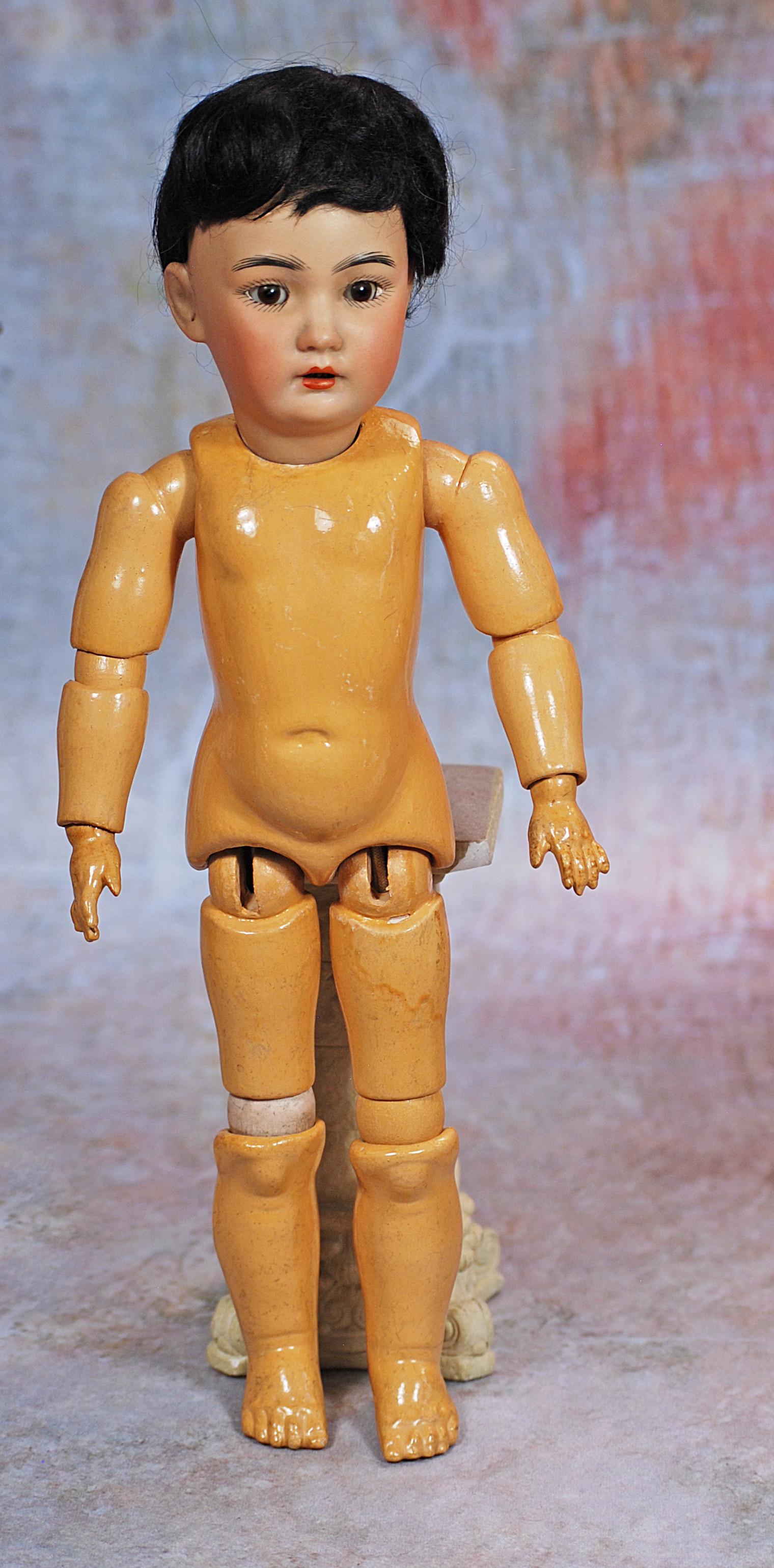 GERMAN BISQUE ASIAN PORTRAIT DOLL BY SIMON & HALBIG: 277. GERMAN BISQUE ASIAN PORTRAIT DOLL BY SIMON & HALBIG. 13”. Marks: Halbig S & H Germany 1329. Amber tinted bisque socket head, brown sleep eyes, painted lashes, feathered brows, pierced ears,