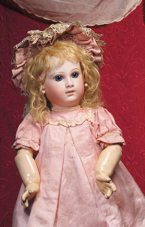 EXCEPTIONAL EARLY MODEL OF JUMEAU BEBE KNOWN AS "PO: EXCEPTIONAL EARLY MODEL OF JUMEAU BEBE KNOWN AS "PORTRAIT" WITH ORIGINAL BOUTIQUE LABEL. Marks: 10 (incised); body: Jumeau Medaille d'or Paris stamp & original boutique label (see photo insert). 23". 