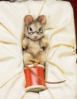THE MOUSE TAILOR BY R. JOHN WRIGHT. 3". Shaded b: THE MOUSE TAILOR BY R. JOHN WRIGHT. 3". Shaded brown mohair mouse with pink felt-lined ears, resin paws, bead eyes, long tail, black reading glasses, seated on wooden spool of silk thread, storybook "
