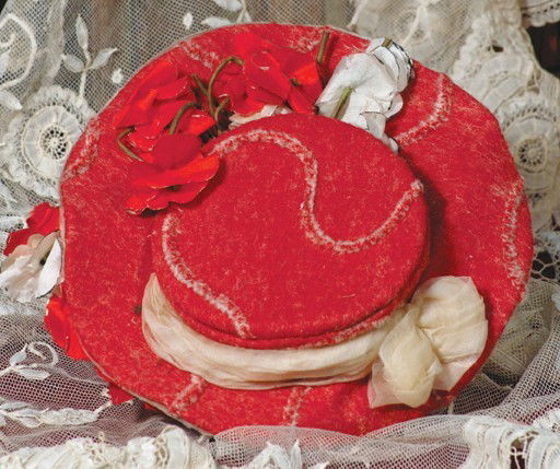 ANTIQUE RED BRUSHED FELT BONNET WITH SHIRRED ORGAN: ANTIQUE RED BRUSHED FELT BONNET WITH SHIRRED ORGANZA BRIM. 2 ¾" inside cap width. Flat crown is firmly shaped and covered in brushed red felt with swirl design, organza band, red and white silk flowe