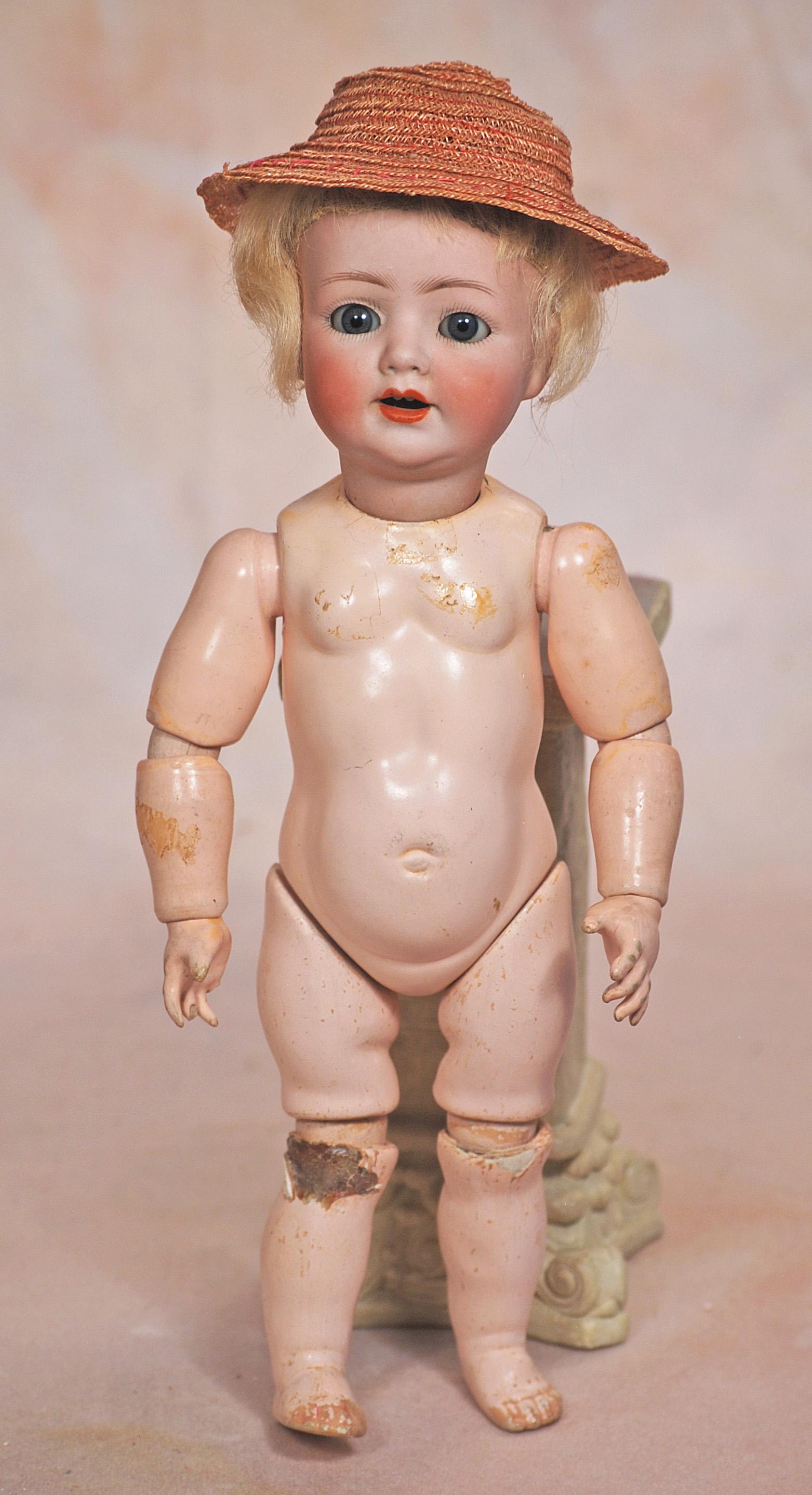 PETITE GERMAN BISQUE TODDLER BY FRANZ SCMIDT: PETITE GERMAN BISQUE TODDLER BY FRANZ SCMIDT. 10”. Marks: 1310 F S & C. Simon & Halbig, made in Germany. Bisque socket head, blue sleep eyes, painted lashes, feathered brows, open mouth, accente