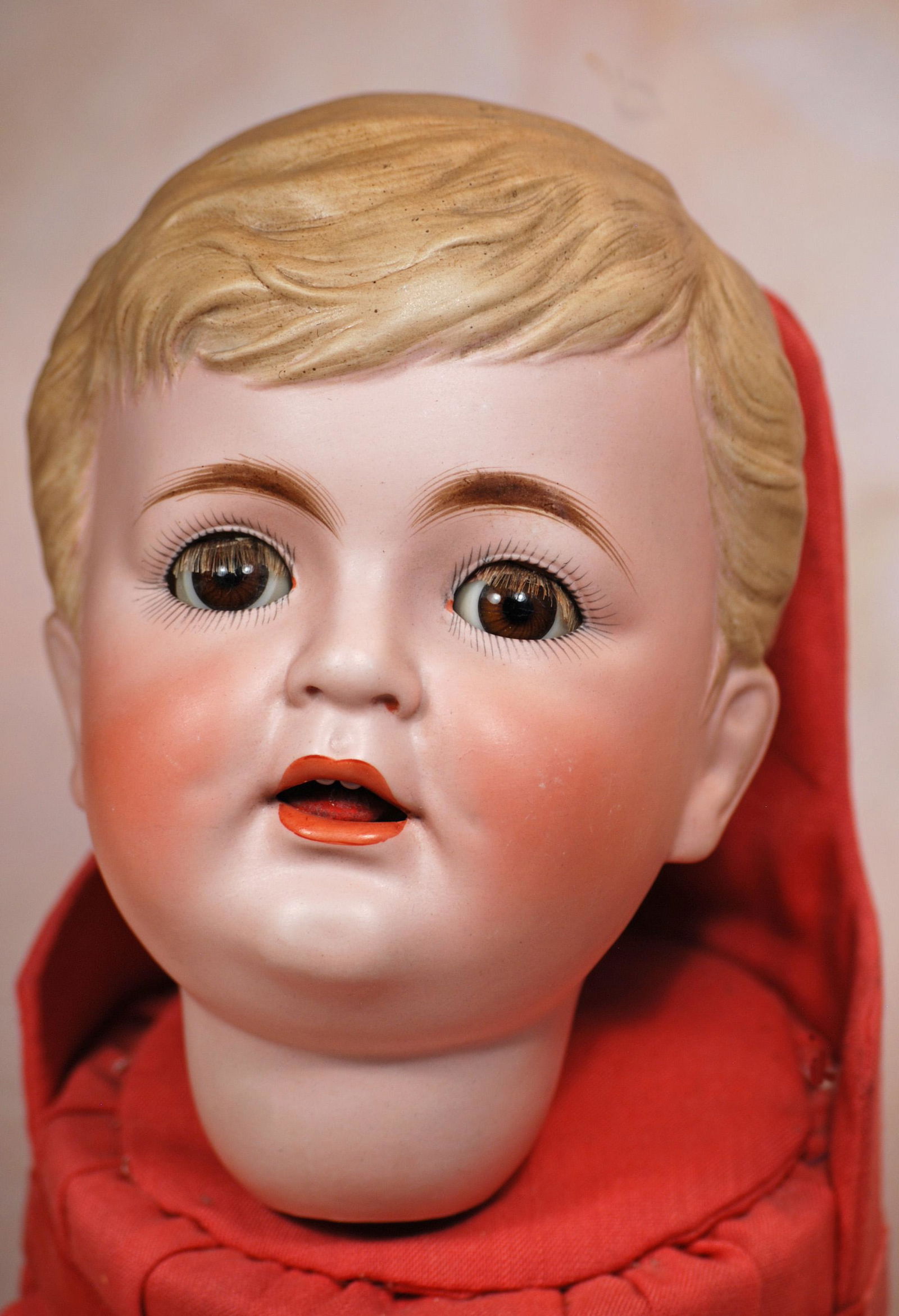 RARE GERMAN BISQUE CHARACTER BOY DOLL HEAD WITH SCULPTED HAIR AND GLASS EYES.: RARE GERMAN BISQUE CHARACTER BOY DOLL HEAD WITH SCULPTED HAIR AND GLASS EYES. Marks: made in Germany 267/50. Solid dome bisque socket head with exceptionally deep sculpting of hair which is arranged i