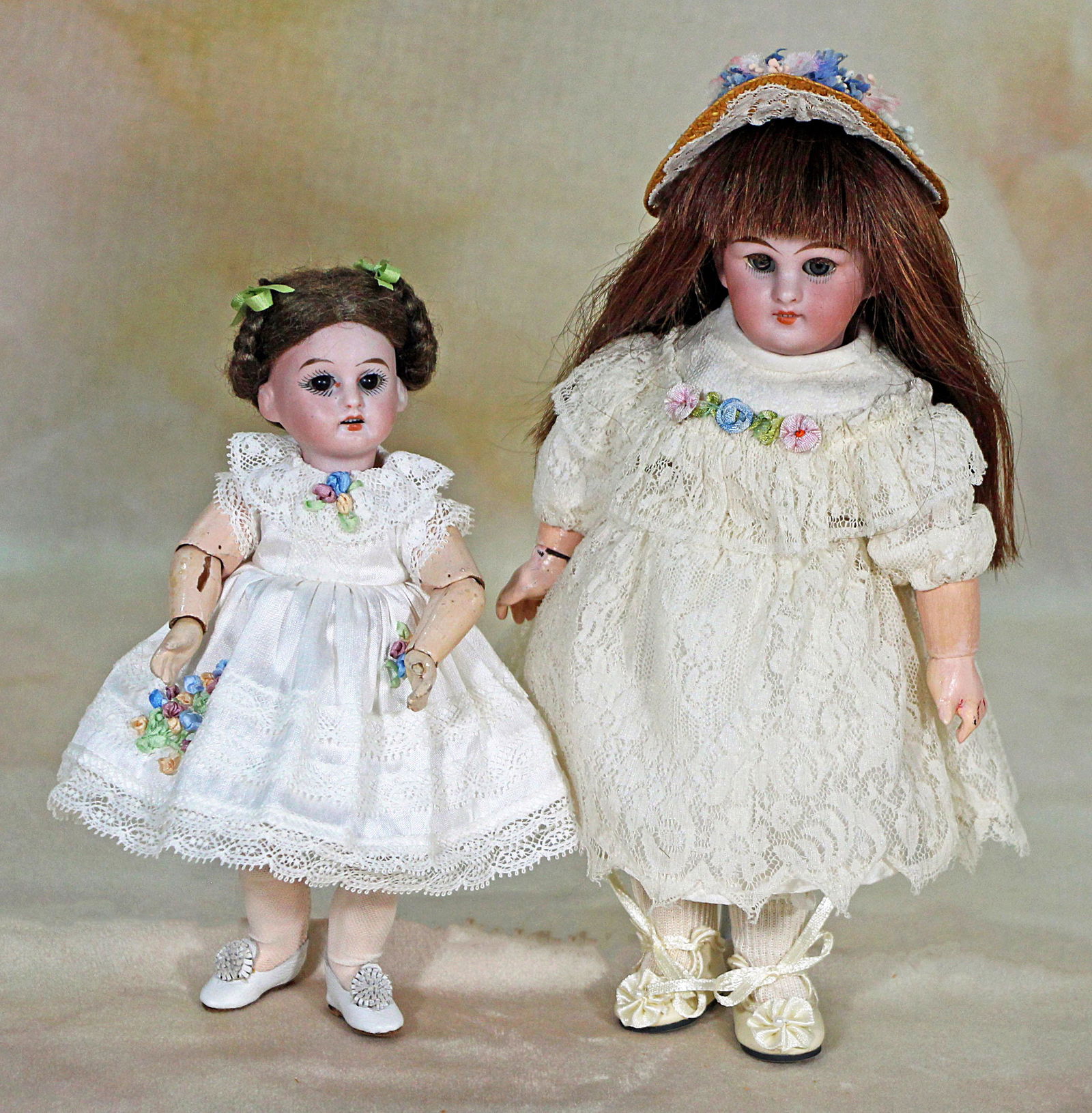 TWO PETITE GERMAN BISQUE DOLLS: TWO PETITE GERMAN BISQUE DOLLS. 9” Simon Halbig doll, marked 749, has bisque socket head, blue sleep eyes, applied upper and painted lower lashes, open mouth, upper teeth, mohair wig, fully join