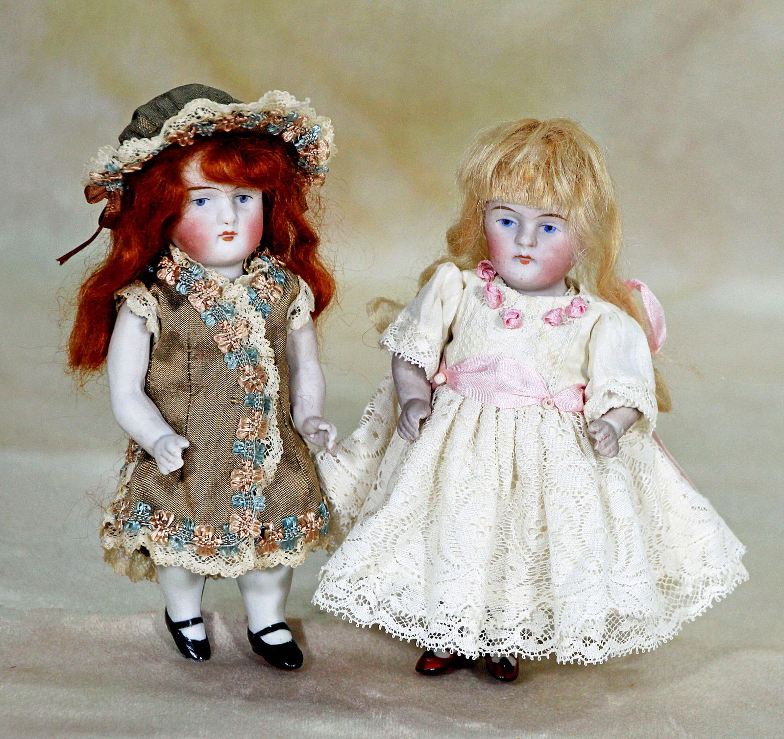 TWO ALL BISQUE DOLLS: TWO ALL BISQUE DOLLS. 5 ½” each. Red hair doll is marked 130, blonde hair doll is marked 120.3. Both have painted features, stockings, and shoes and are jointed at shoulders and hips. Comme