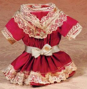 ANTIQUE DRESS FOR SMALL DOLL: ANTIQUE DRESS FOR SMALL DOLL. 2 ½" shoulder width, 4 ½" length. Ruby red silk dress has shirred front, inset short sleeves, trimmed with lace at bodice, sleeves and hemline, ribbon at waist, back cl