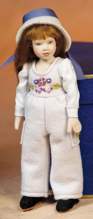 MAGGIE MADE FELT DOLL "KIM": MAGGIE MADE FELT DOLL "KIM". Marks: M. Iocono (shoe). 8". All felt doll with swivel head, jointed body, painted features, brown mohair wig with bangs, pastel felt costume and hat, in original box. Com