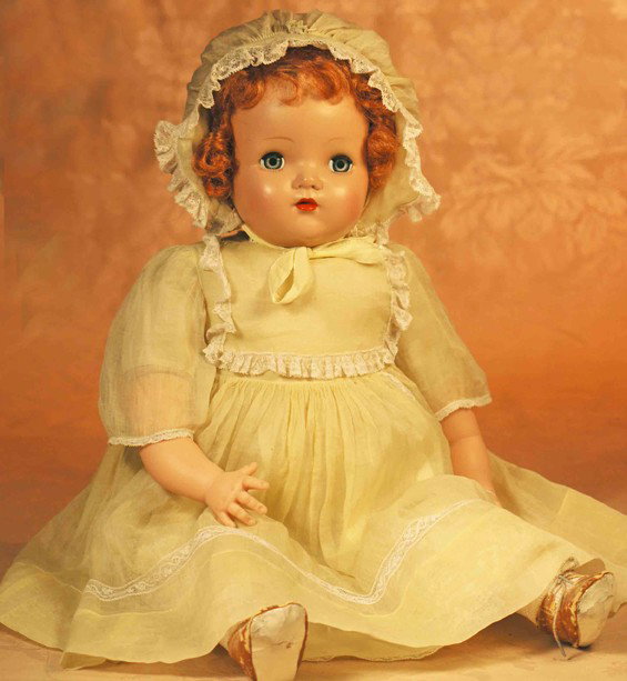1941 ALEXANDER "BITSY" BABY DOLL: 1941 ALEXANDER "BITSY" BABY DOLL. 24". Hard plastic swivel head on cloth body with vinyl limbs, auburn synthetic wig, blue sleep eyes, painted and applied lashes, feathered brows, closed mouth, tagged