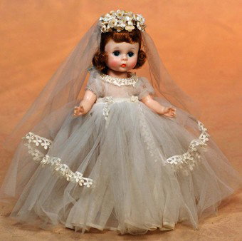 ALEXANDER-KIN CIRCA 1961"BRIDE" DOLL: ALEXANDER-KIN CIRCA 1961"BRIDE" DOLL. 8". All-hard plastic, bend-knee-walker, dark auburn hair, blue sleep eyes, tagged tulle over cotton gown with dainty lace trim, pearl-edged neckline, taffeta pant