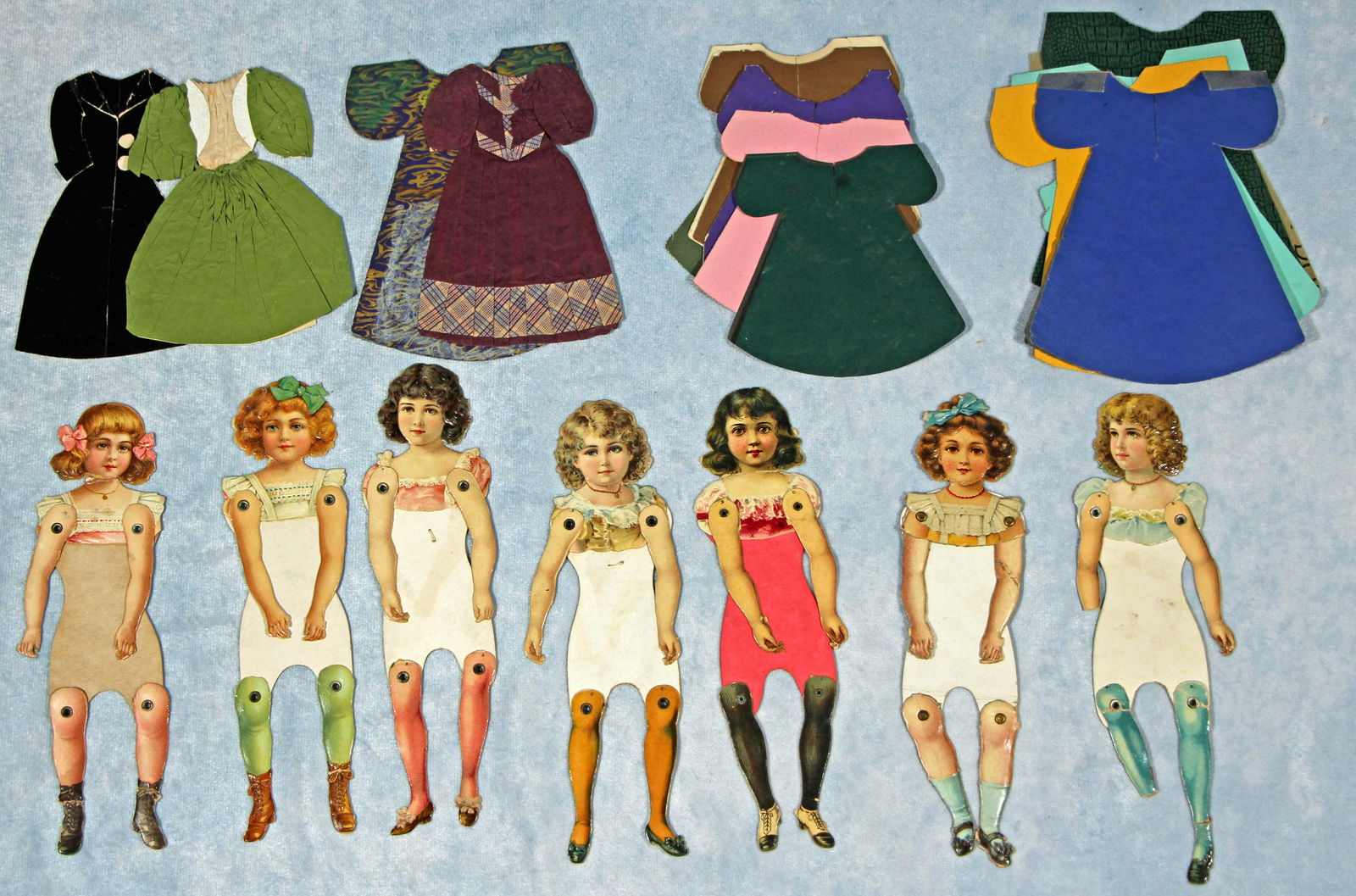 NINE JOINTED VICTORIAN PAPER DOLLS WITH HANDMADE DRESSES. (1 of 2)