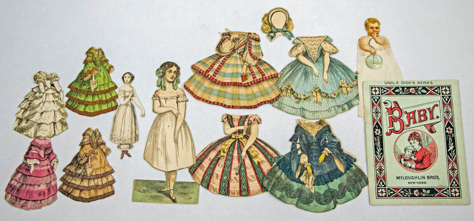 TWO MCLOUGHLIN PAPER DOLLS, ONE BOOK, AND ONE VICTORIAN BABY (1 of 2)