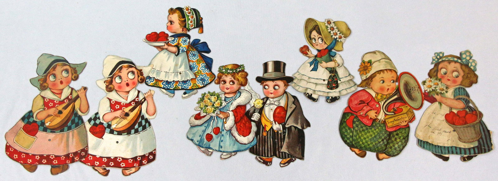 EIGHT VALENTINE GREETING WALKING DOLLS PRINTED IN GERMANY: 125. EIGHT VALENTINE GREETING WALKING DOLLS PRINTED IN GERMANY. 6 1/4" to 8 1/2" Tall. Eight lithographed, engraved, die cut, heavy cardboard valentine paper doll, each with walking mechanism. And, fo