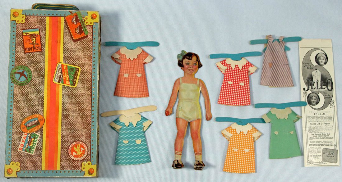 FREE STANDING PAPER DOLL WITH TRUNK: 230. FREE STANDING PAPER DOLL WITH TRUNK. 8" heavy cardboard front and back paper doll with fold out shoes as stand, has letter S on shorts. Comes with cute front and back dresses and 5 1/2" x 10 1/2"