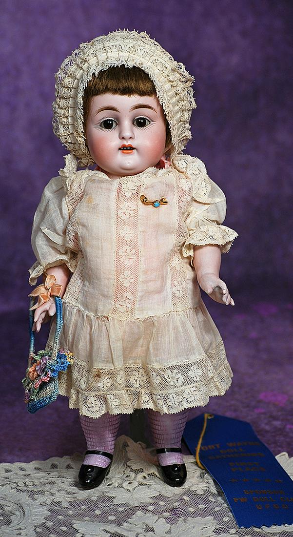 LARGE KESTNER ALL-BISQUE DOLL WITH LAVENDER STOCKINGS. 11”. Marks: 150/ 6. All-bisque child: LARGE KESTNER ALL-BISQUE DOLL WITH LAVENDER STOCKINGS. 11”. Marks: 150/ 6. All-bisque child jointed at shoulders and hips, painted lavender knee stockings and black one-strap heeled shoes, brown