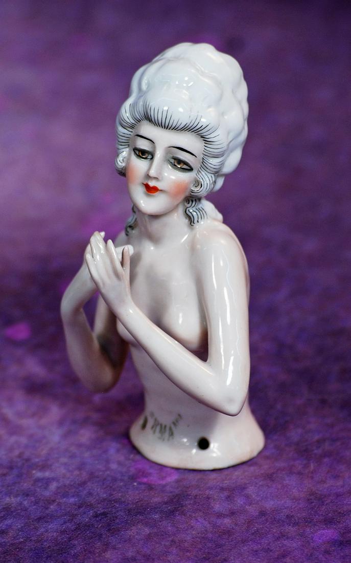 GERMAN PORCELAIN HALF DOLL WITH ARMS AWAY. 4”. Porcelain, pink-toned, waist-up nude figure: GERMAN PORCELAIN HALF DOLL WITH ARMS AWAY. 4”. Porcelain, pink-toned, waist-up nude figure of lady with both arms posed away from body, white hair in elaborate coiffure having fine stippling det