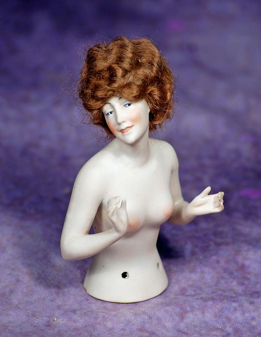 GERMAN BISQUE HALF DOLL WITH ORIGINAL WIG. 4 ½”. All-bisque waist-up nude figure of: GERMAN BISQUE HALF DOLL WITH ORIGINAL WIG. 4 ½”. All-bisque waist-up nude figure of adult woman with painted blue side-glancing eyes, arched brows, open/closed mouth, original brown mohair