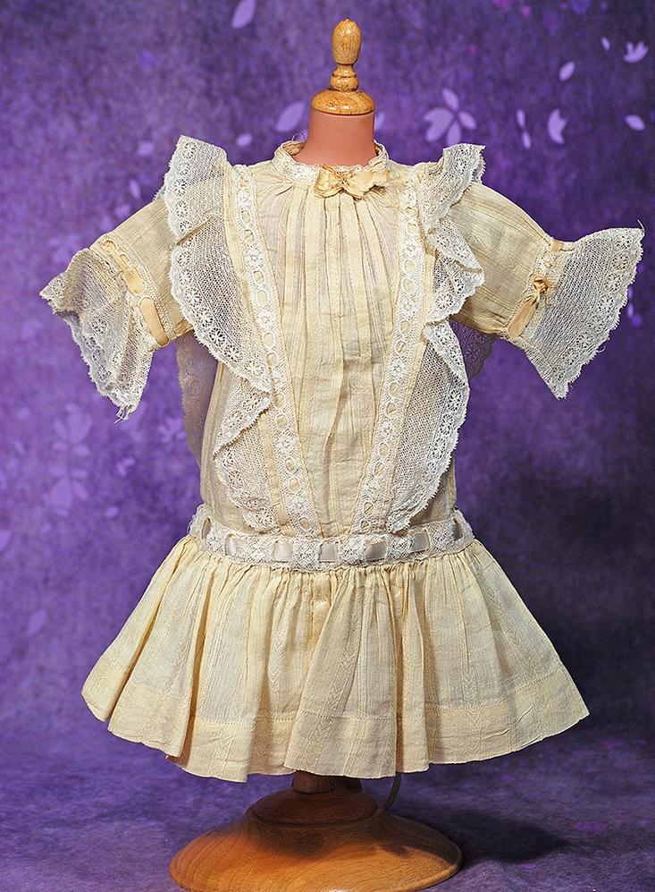 ANTIQUE DOLL DRESS.  Pale cream color voile made up in dress with dropped waist, pleated plastron (1 of 1)