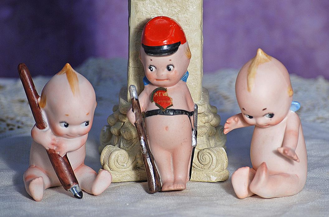 THREE GERMAN BISQUE KEWPIES. 3 ½” - 4”. Marks: O’Neill and C in circle.: THREE GERMAN BISQUE KEWPIES. 3 ½” - 4”. Marks: O’Neill and C in circle. Each is all-bisque figure with painted classic Kewpie features, blonde topknot and side curls. Includes: