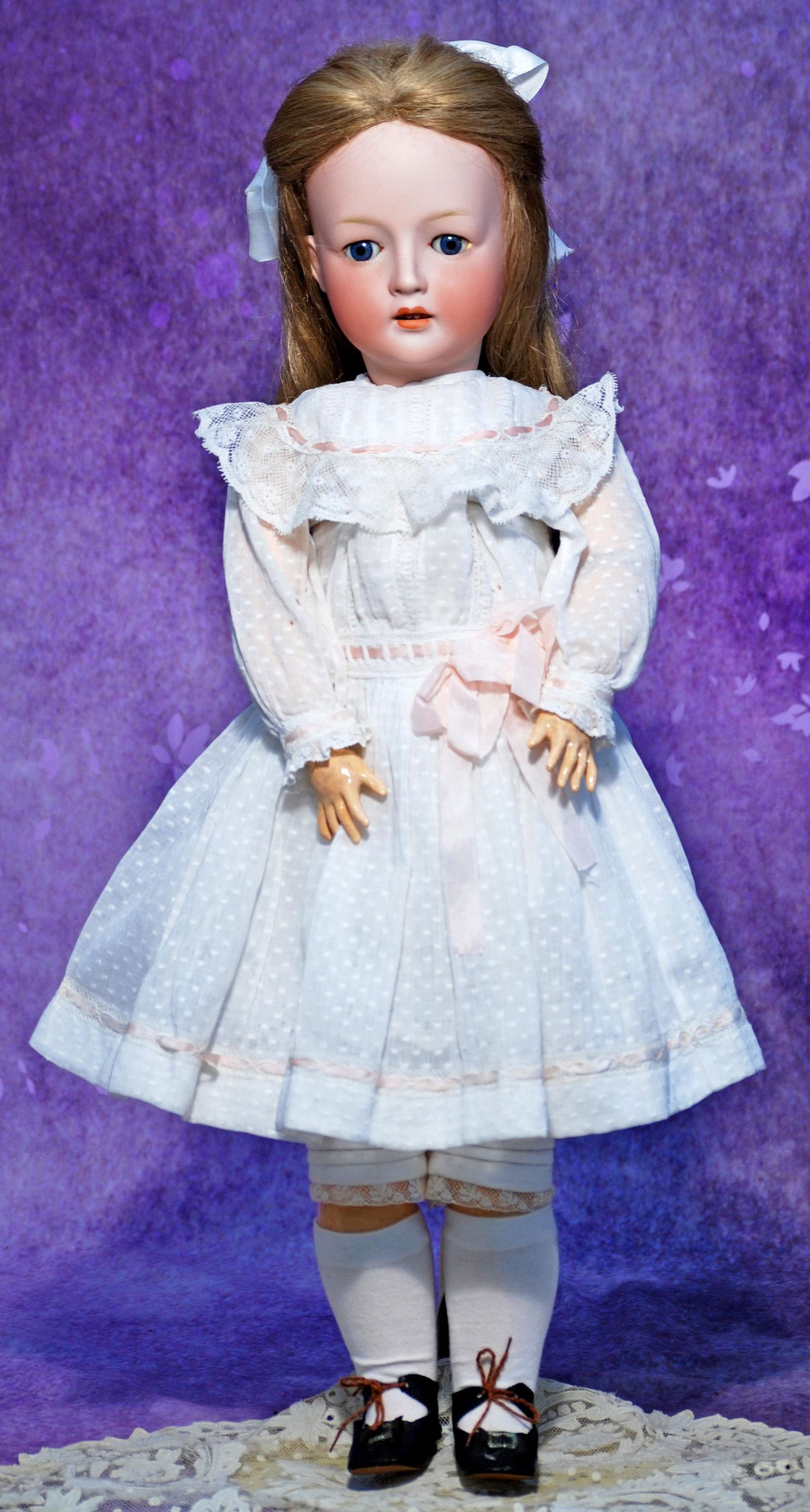 GERMAN BISQUE CHILD BY REVALO. 25”. Marks: Revalo 8. Bisque socket head, blue eyes, painted: GERMAN BISQUE CHILD BY REVALO. 25”. Marks: Revalo 8. Bisque socket head, blue eyes, painted lower lashes, applied upper lashes, feathered brows, open mouth, upper teeth, blonde synthetic wig, co