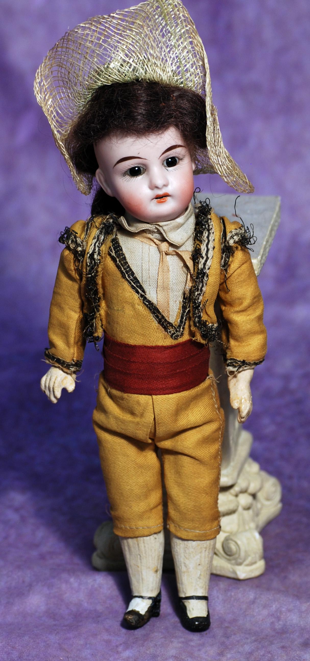 PETITE GERMAN BISQUE DOLL BY KUHNLENZ. 9”. Marks: G br K. Bisque socket head, stationary: PETITE GERMAN BISQUE DOLL BY KUHNLENZ. 9”. Marks: G br K. Bisque socket head, stationary brown glass eyes, tapered brows, open mouth, upper teeth, original brunette mohair wig, five-piece paper