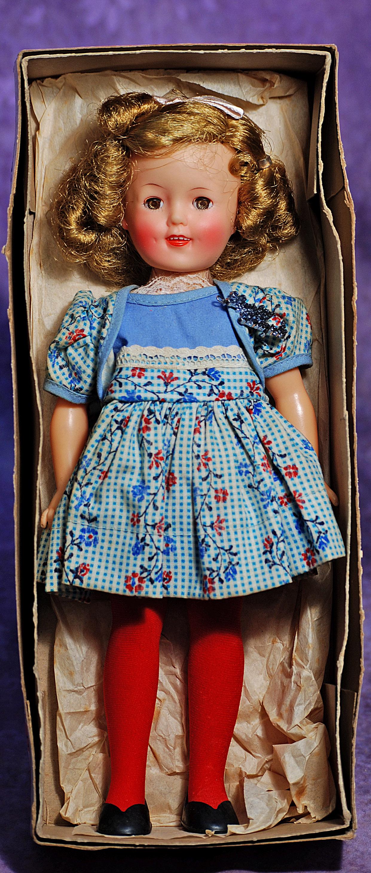 SHIRLEY TEMPLE 1957 DOLL IN ORIGINAL BOX. 12”. Vinyl socket head on five-piece jointed body,: SHIRLEY TEMPLE 1957 DOLL IN ORIGINAL BOX. 12”. Vinyl socket head on five-piece jointed body, sleep eyes, smiling mouth with molded teeth, original wig in original set, tagged cotton school dress