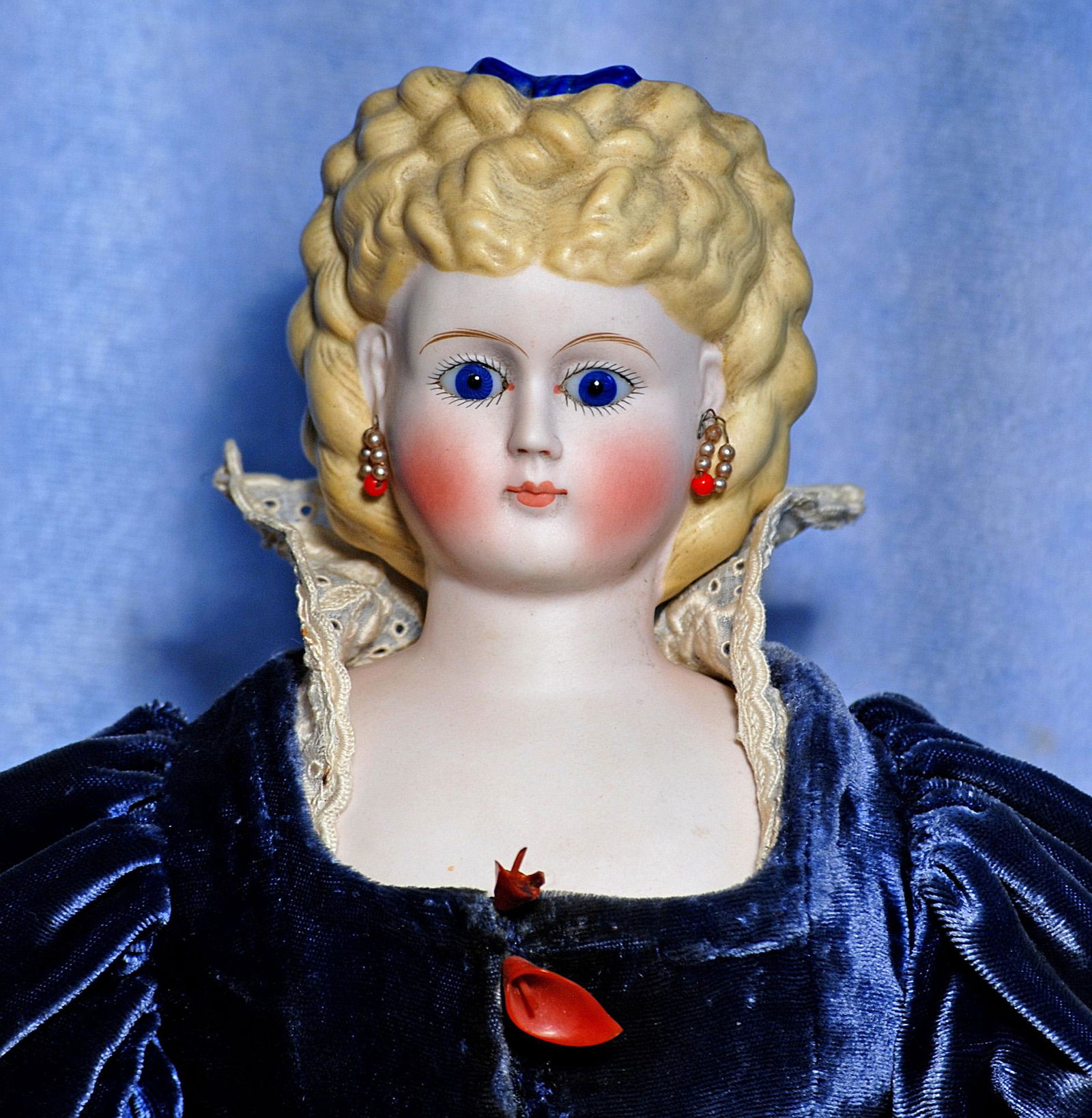 GERMAN BISQUE PARIAN LADY WITH GLASS EYES AND ELABORATE COIFFURE. 20”. Marks: None visible.: GERMAN BISQUE PARIAN LADY WITH GLASS EYES AND ELABORATE COIFFURE. 20”. Marks: None visible. Bisque shoulderhead with deeply-sculpted blonde hair arranged in fancy curls and braids and further ac