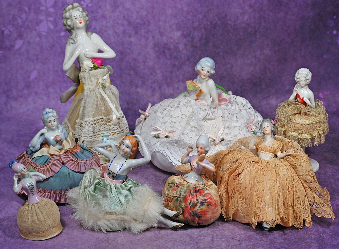 GROUP OF EIGHT PORCELAIN PINCUSHION DOLLS. (1 of 1)