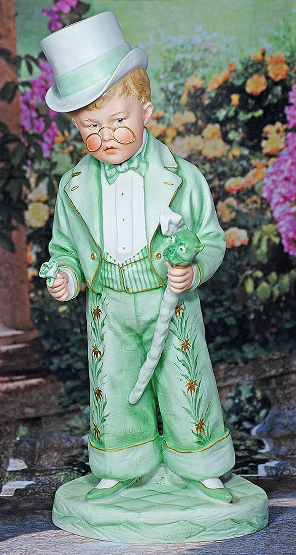 LARGE BISQUE FIGURINE OF LAD IN GREEN SUIT WITH GOLD-RIMMED EYE GLASSES.  16”.  All-bisque (1 of 1)