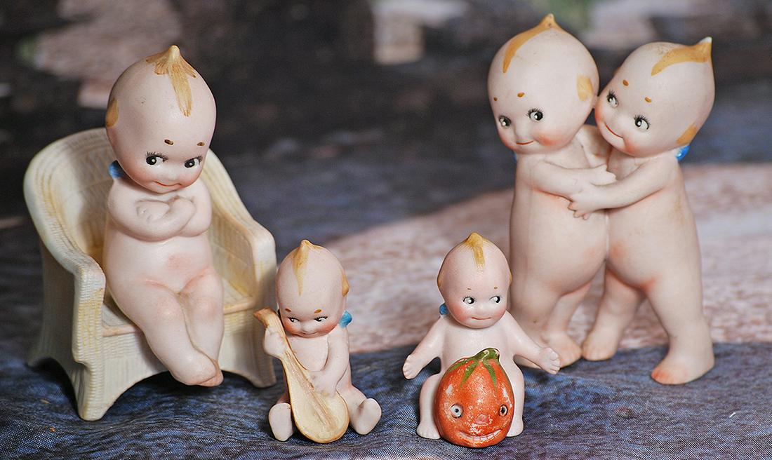 FOUR GERMAN BISQUE KEWPIES.  Each is all bisque figure with painted topknot and side curls, classic (1 of 1)