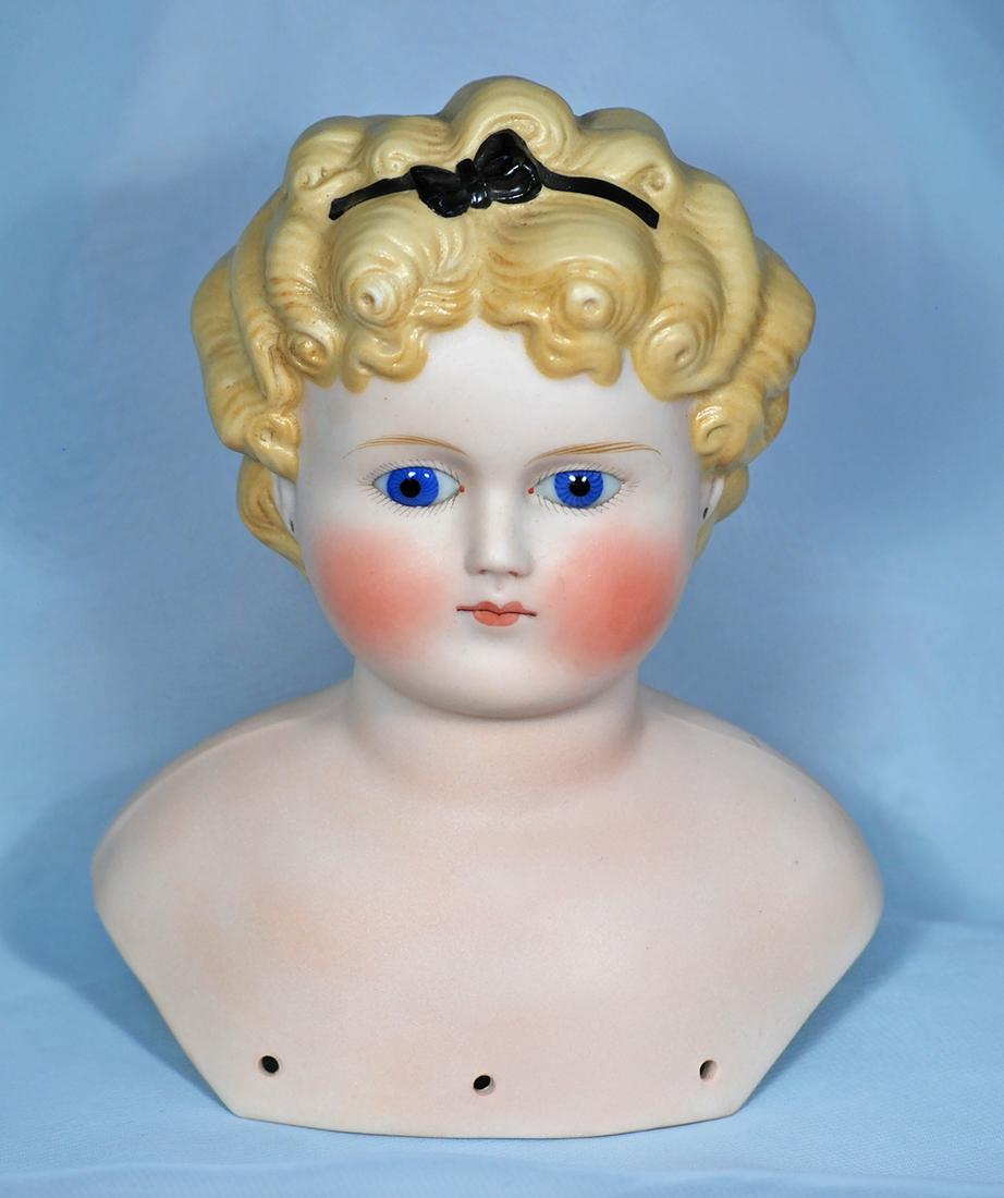 GERMAN BISQUE DOLL HEAD WITH SCULPTED HAIR AND GLASS EYES.  7”.  Bisque shoulderhead with (1 of 1)