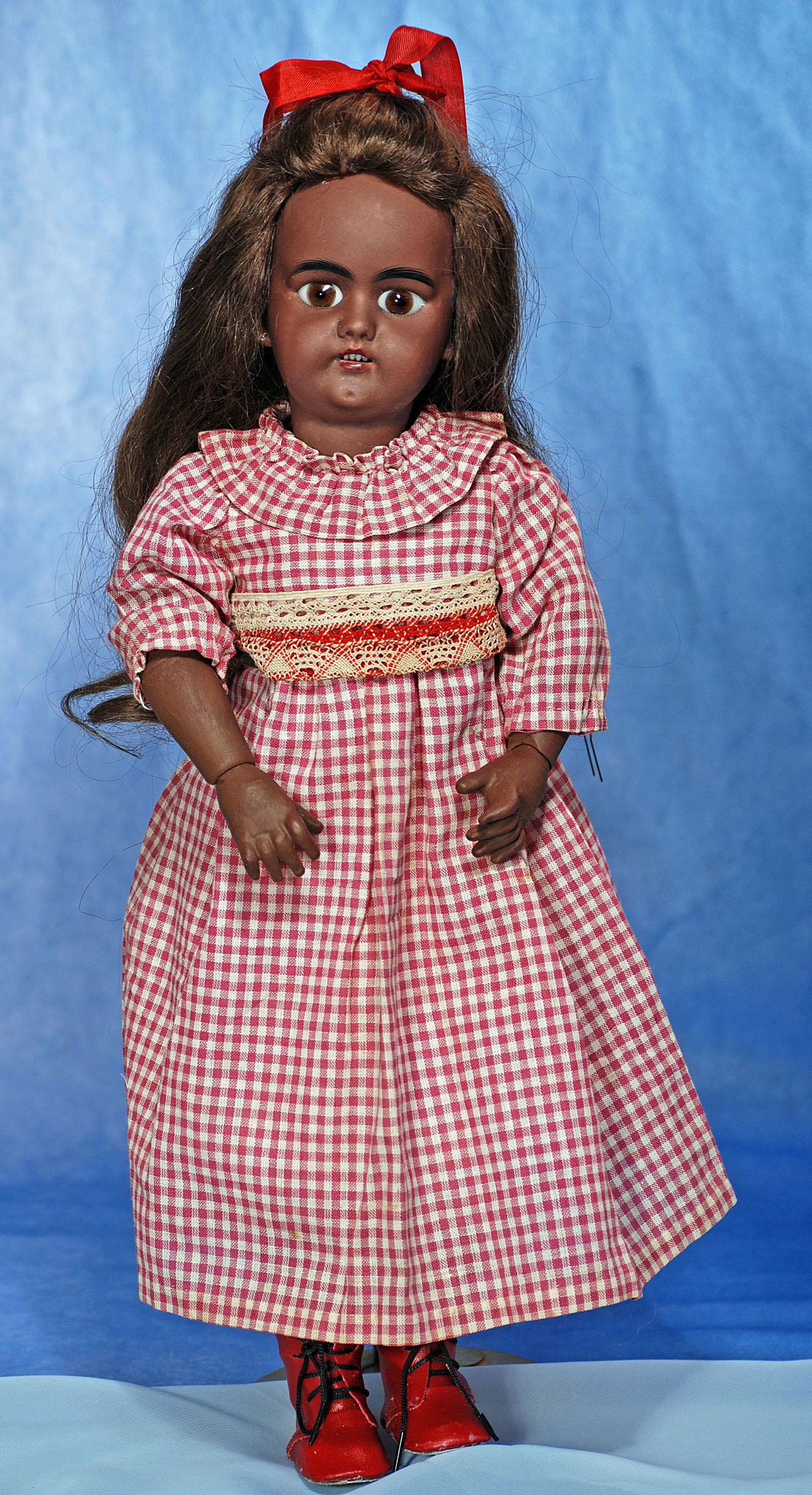 SIMON AND HALBIG CHILD WITH BROWN COMPLEXION. 18”. Marks: S H 1079 Dep Germany. Brown: SIMON AND HALBIG CHILD WITH BROWN COMPLEXION. 18”. Marks: S H 1079 Dep Germany. Brown bisque socket head, stationary brown glass eyes, painted lashes, black brows, pierced ears, open mouth, uppe