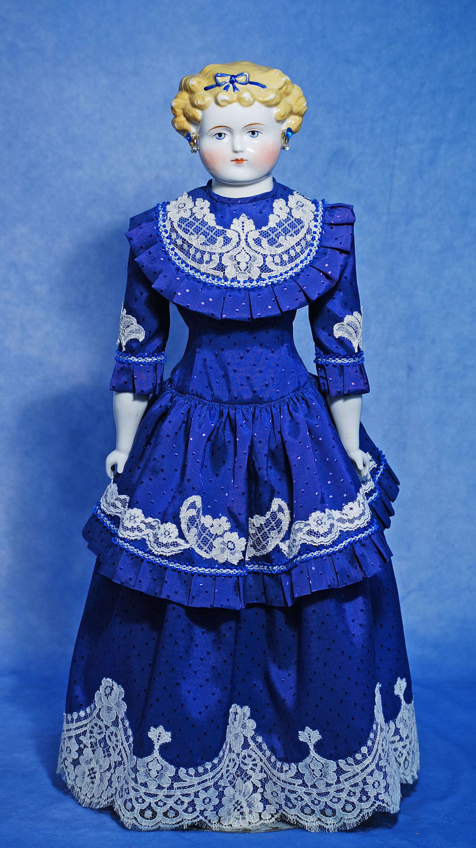 GERMAN PORCELAIN LADY WITH BLONDE HAIR AND BLUE RIBBON. 24”. Porcelain shoulderhead with: GERMAN PORCELAIN LADY WITH BLONDE HAIR AND BLUE RIBBON. 24”. Porcelain shoulderhead with sculpted blonde hair in the Dolly Madison style, accented with royal blue hair ribbon, painted features,