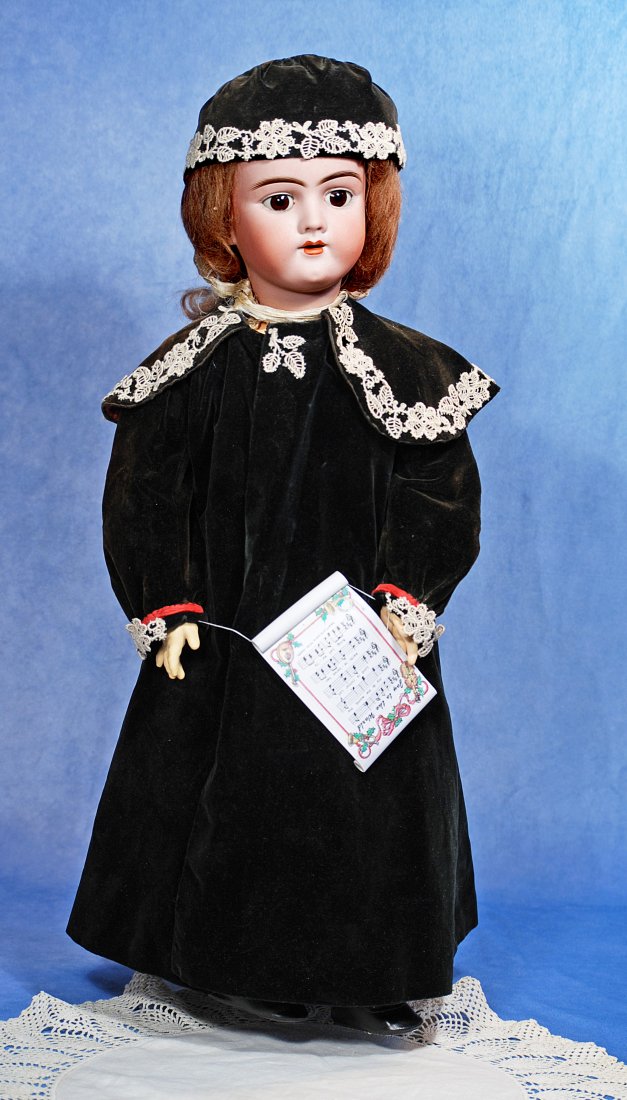 GERMAN BISQUE DOLL BY HANDWERCK: 24". Marks: 109. Bisque socket head, brown sleep eyes, painted lashes, feathered brows, pierced ears,open mouth, accented lips, uper teeth, brown mohair wig, composition ball-jointed body, black velve