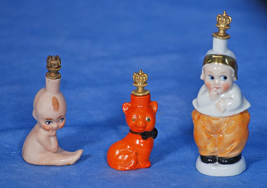 KEWPIE AND TWO OTHER MINIATURE PERFUME BOTTLES. (1 of 1)